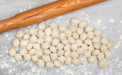 Fresh raw homemade handmade pelmeni (dumplings) with minced meat or fish. Home food concept. Selective focus, top view