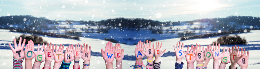 Children Hands Building Colorful Word Together We Are Stronger. Snowy Winter Background With...