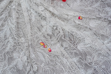 White wooden background with white spring flowers roses and lace ribbon. Happy womans day. The...
