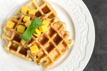 homemade Belgian waffles with caramel syrup.