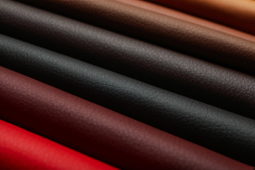 Different leather samples as background, closeup view