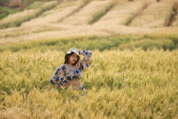 Naklejka na ściany i meble Woman enjoying nature in a farm field