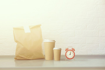 Paper bag on table against white background. Mockup for design