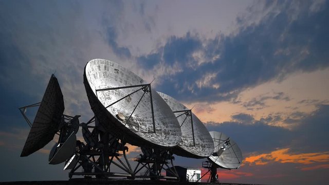 Satellite antennas at sunset, information technology astronomical research