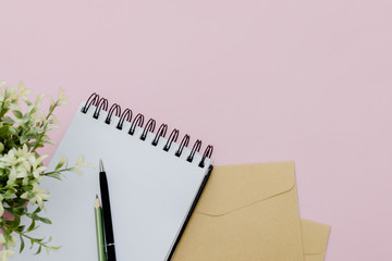 Stationary concept, Flat Lay top view Photo of pencil, pen  and notepad  on a pink abstract background with copy space, minimal .