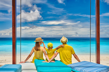 Family with three year old boy on beach. Seychelles, Mahe.