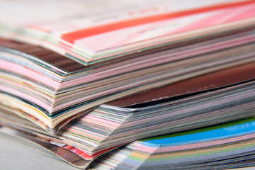 Abstract background image of stacked magazines. Selective focus