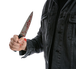 Man with bloody knife on white background, closeup. Dangerous criminal