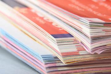 Abstract background image of stacked magazines. Selective focus