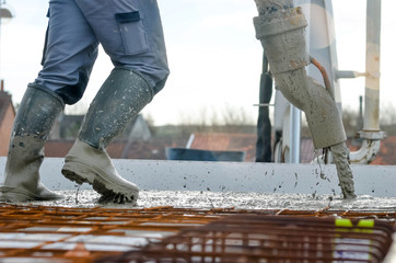 team of workers spreading concrete on site