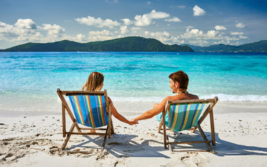 Couple in loungers on a beach at Thailand