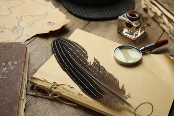 Composition with different vintage items on wooden table, closeup. Detective's workplace