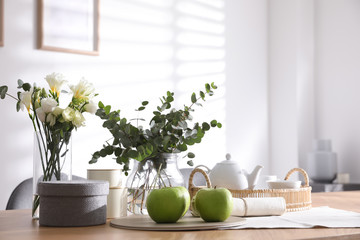 Fototapeta na wymiar Apples and tea set on wooden table indoors. Stylish interior design
