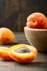 Ripe apricots in a wooden bowl.