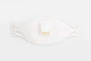Fototapeta premium Protective face mask with filter for face from contamination, viruses, flu and coronavirus on white background . top view.Health care and surgical concept.