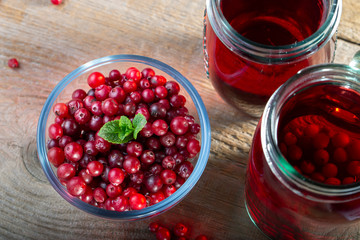 Cranberry juice and fresh cranberries on the table.