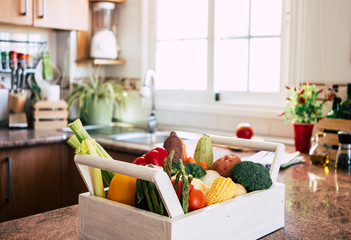 In the kitchen assortment of fresh raw vegetables in a white basket. Healthy lifestyle concept - detox diet