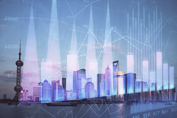 Forex graph on city view with skyscrapers background double exposure. Financial analysis concept.