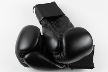 Close-up of black boxing gloves on white background.