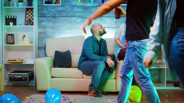 Beautiful young woman slaps young man at his friends party