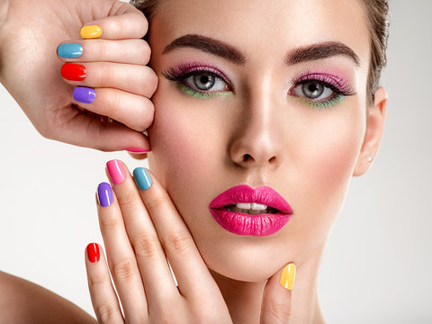 Beautiful fashion woman with a colored nails. Attractive white girl with multicolor manicure.