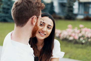 Fototapeta premium Young happy couple hugging on the city street