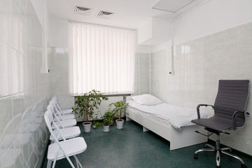 clean and comfortable room for patient in the hospital .  hospital ward with bed, window and chairs for visitors close up. doctor's room close up. hospital check-ins 