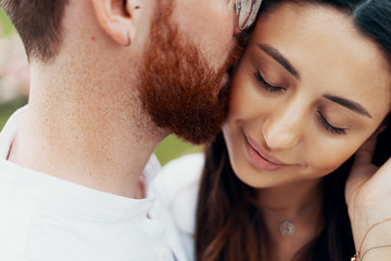Young happy couple hugging on the city street