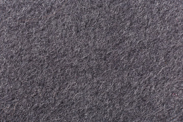 Gray background of felted wool, close up.