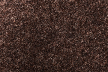 Fototapeta premium Brown background of felted wool, close up.