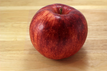 Red gala apple on board