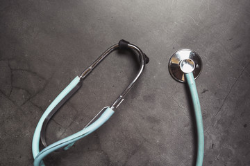Stethoscope isolated on dark background. Copy space, medical concept.