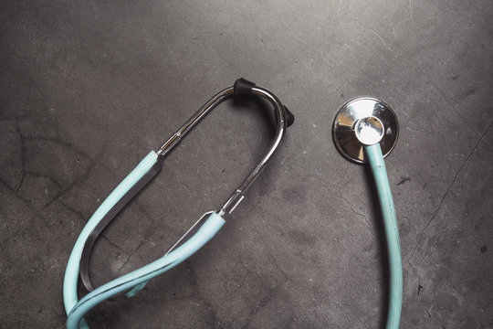 Stethoscope isolated on dark background. Copy space, medical concept.