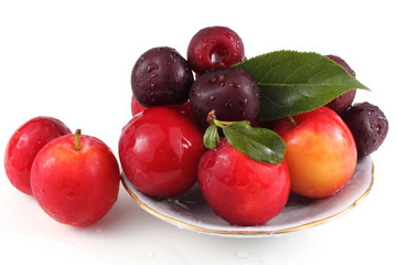 Naklejka na ściany i meble Plums and cherries on dish