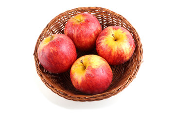 Gala apples on wicker plate
