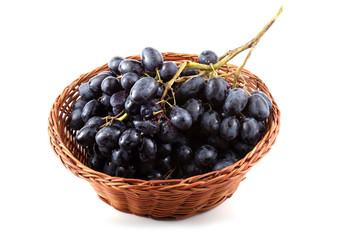 Black grape on wicker plate
