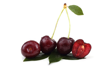 Three cherries with a half and leaves