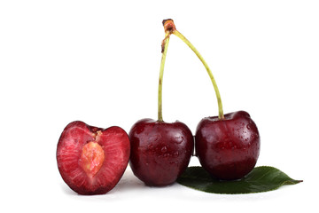 Two cherries with a half and leaves