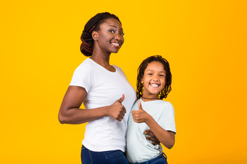 Afro family smiling and gesturing thumbs up