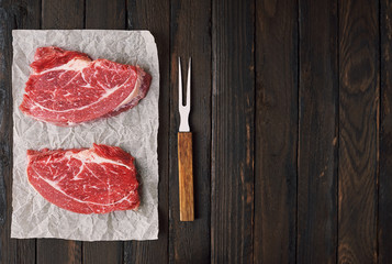 Beef fresh thawed raw meat on a wooden table.