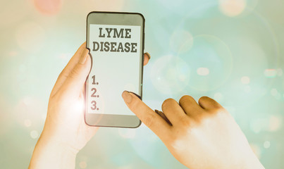 Writing note showing Lyme Disease. Business concept for an inflammatory and infectious disease caused by tick bites