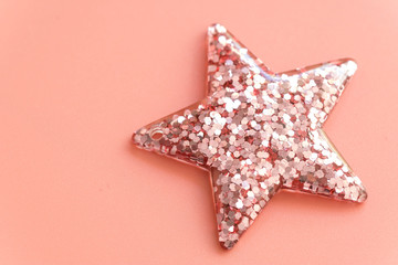 pink color Christmas star isolated on pink background