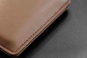 Brown Leather Wallet on black background closeup view