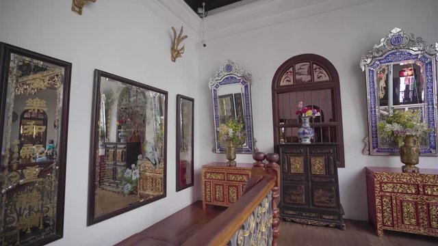 Beautiful Flowers In Ornate Vases On The Small Wooden Tables In Front Of Decorated Mirrors In Peranakan Mansion, Penang, Malaysia - Medium Shot