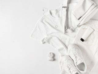 Fashion flat lay with white t shirt, sneakers, waist bag and accessories, monochrome concept, casual look