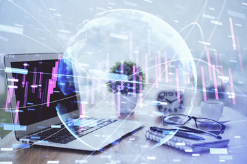 Stock market graph and table with computer background. Double exposure. Concept of financial analysis.