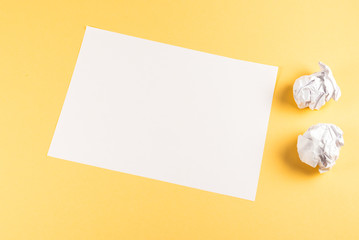 White empty sheet of paper on beige background.