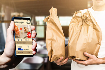 man holding phone with app delivery food screen