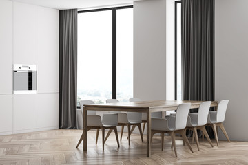 Panoramic white kitchen corner with dining table