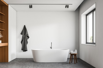 Obraz na płótnie Canvas White bathroom with tub and wooden shelves